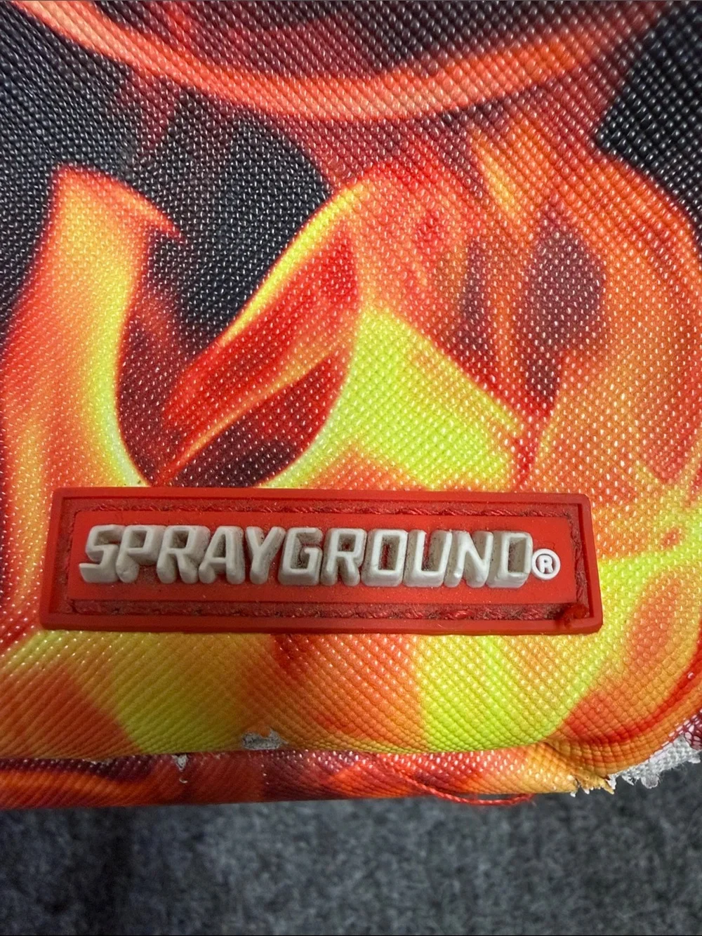Sprayground Black Backpack with Orange Flame & Blue Ice Graphic